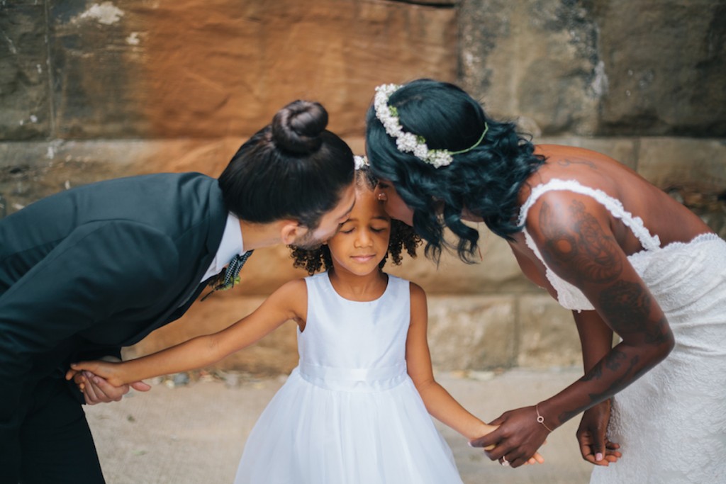 Bride and Groom with Daughter on Wedding Day